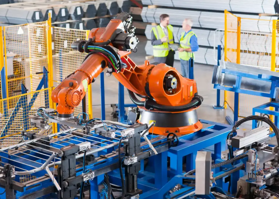 robotic arm assembly line with workers in factory