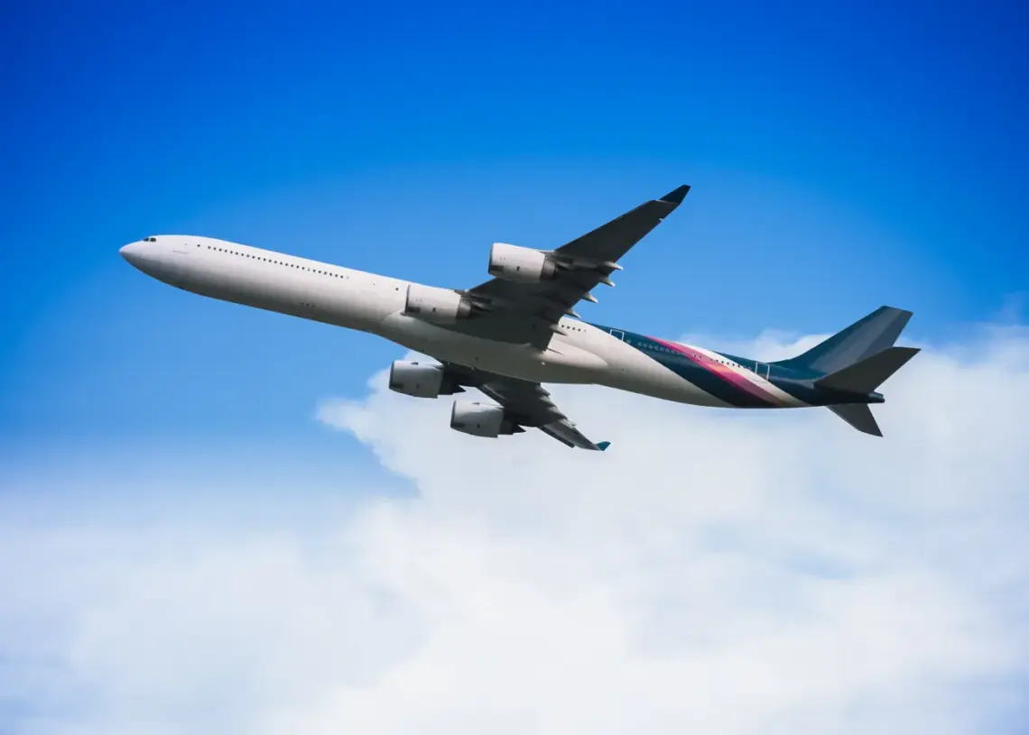 airplane flying through a clear blue sky