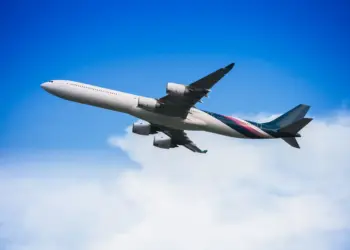 airplane flying through a clear blue sky