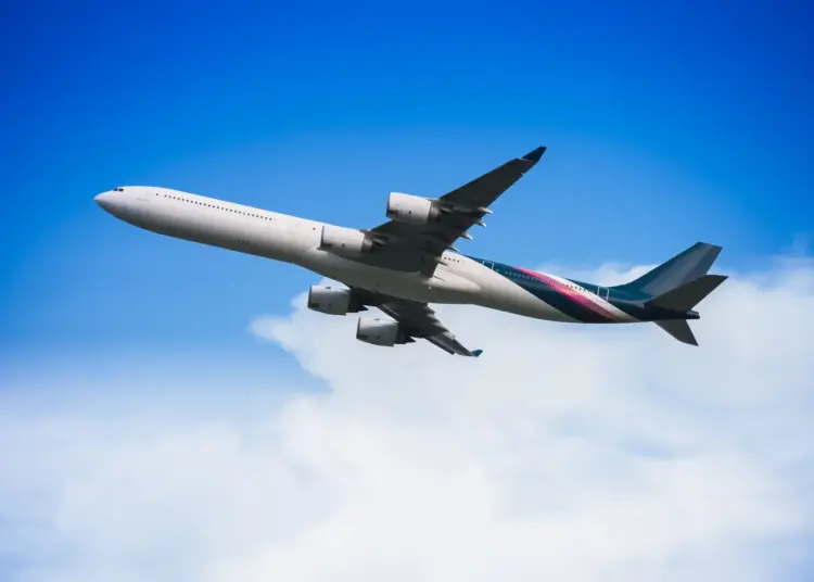 airplane flying through a clear blue sky