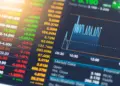 stock market information on tablet with sun flare