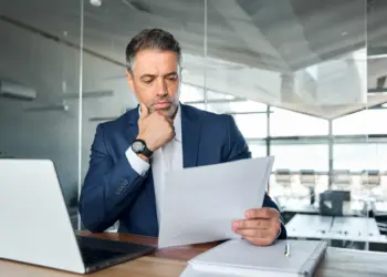 focused businessman reviewing documents in modern