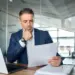 focused businessman reviewing documents in modern