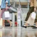 women carry shopping bags walking through shopping
