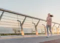teen running on bridge during sunrise