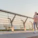 teen running on bridge during sunrise