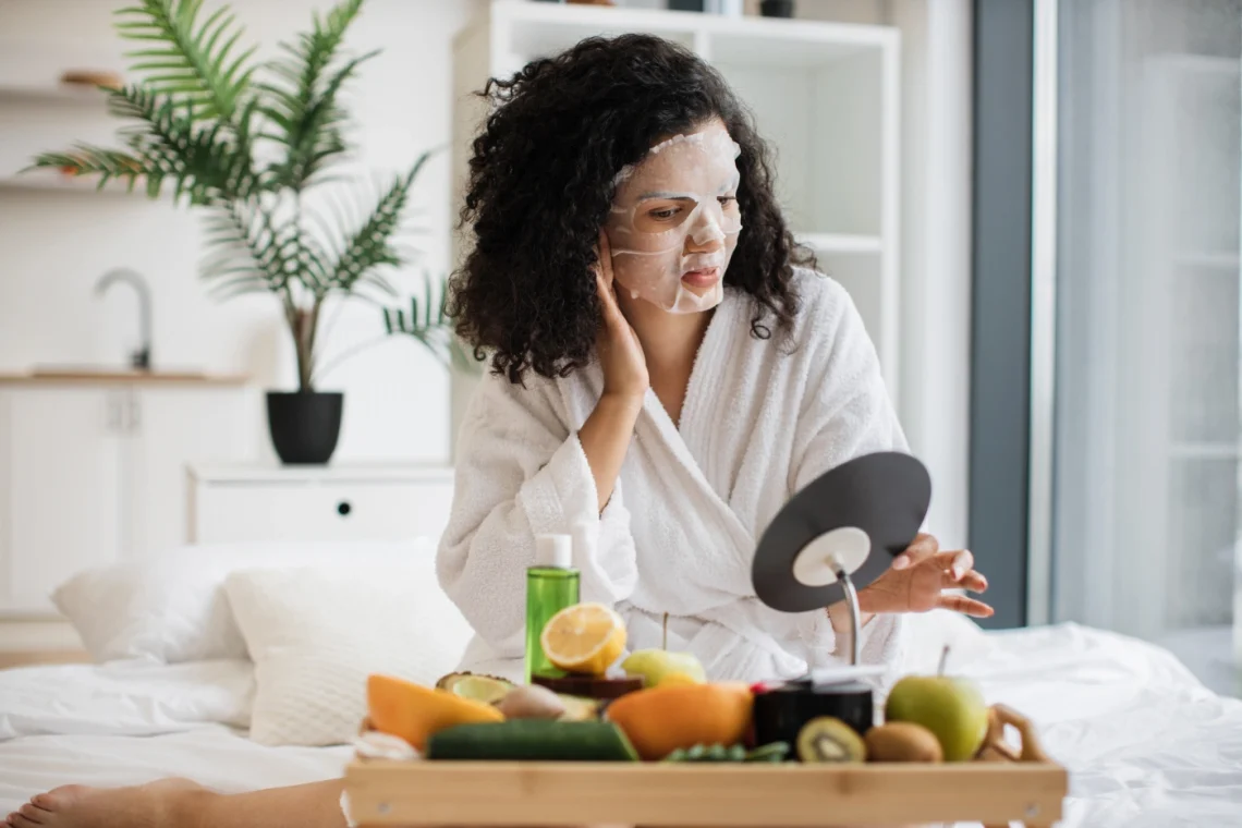 woman applying a facial mask