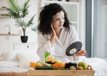 woman applying a facial mask