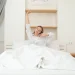 woman waking up and stretching in bed