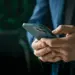 man in suit using smartphone in office