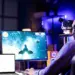 man playing video game wearing headphones at home
