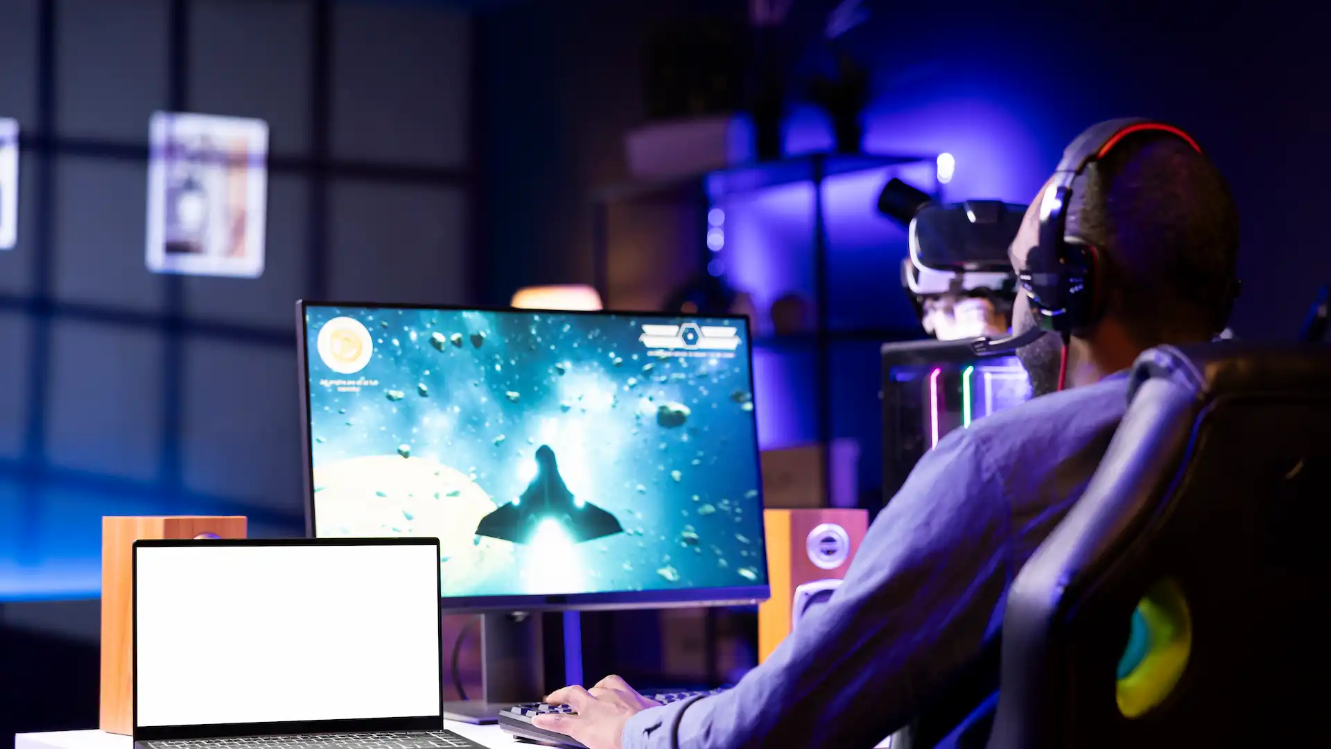 man playing video game wearing headphones at home