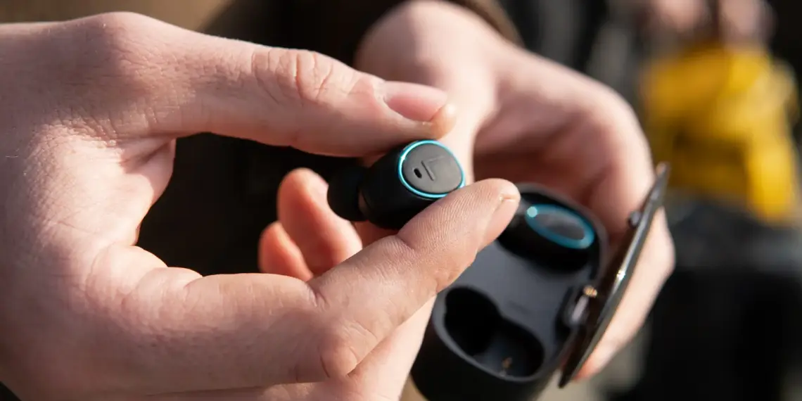 wireless earbud technology being held in hand