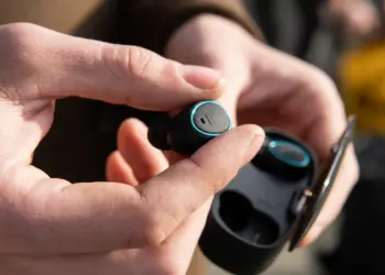 wireless earbud technology being held in hand