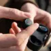 wireless earbud technology being held in hand