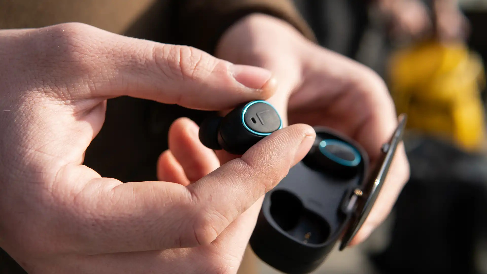 wireless earbud technology being held in hand