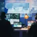 analysts work on computers in dark urban workplace