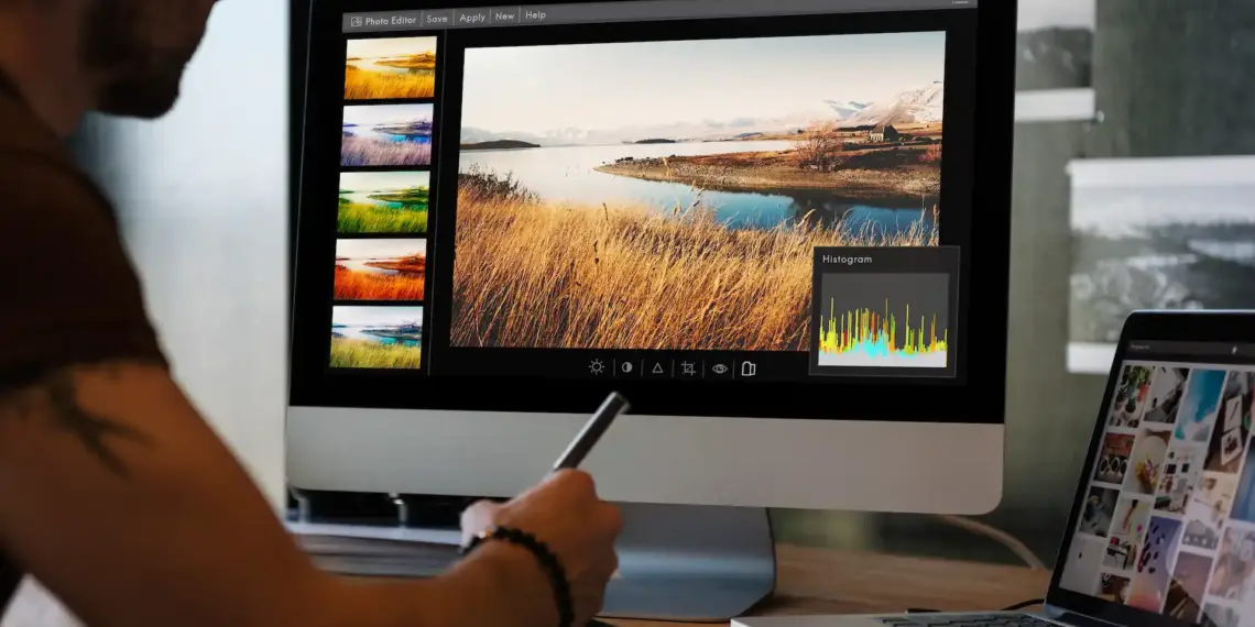 man editing landscape photo on desktop computer