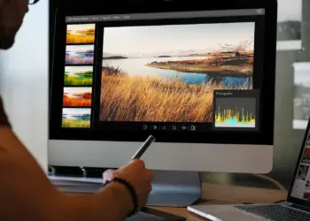 man editing landscape photo on desktop computer