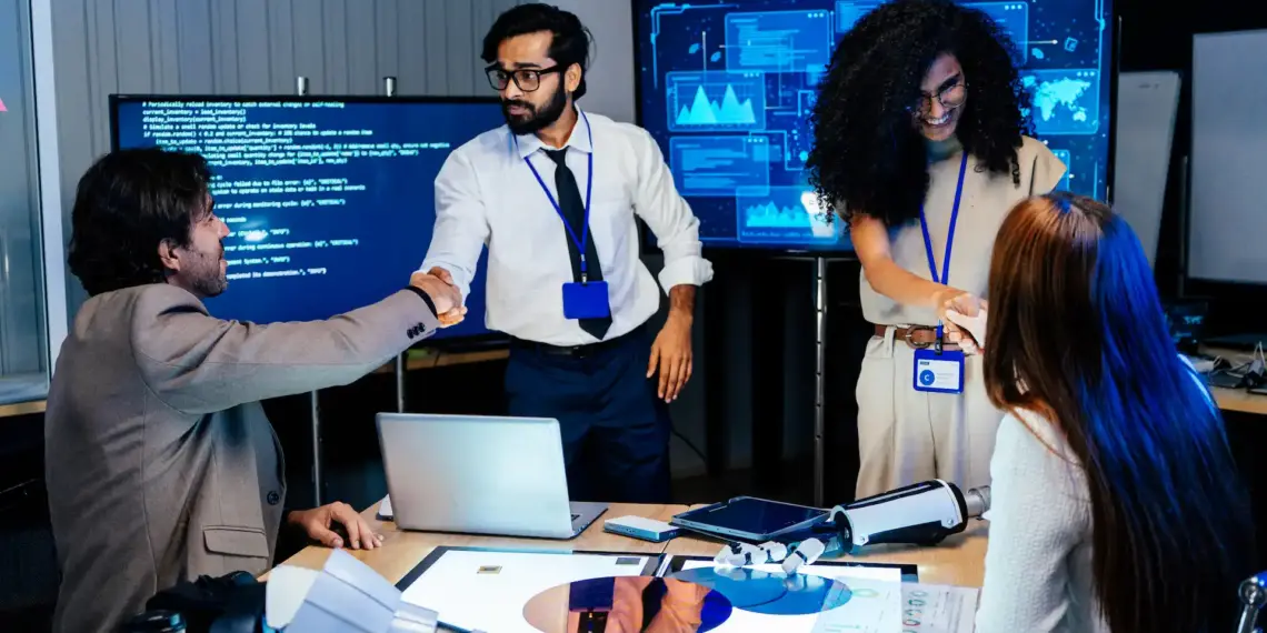 professional tech team shaking hands in modern
