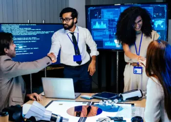 professional tech team shaking hands in modern