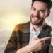 smiling young man pointing at smartwatch device
