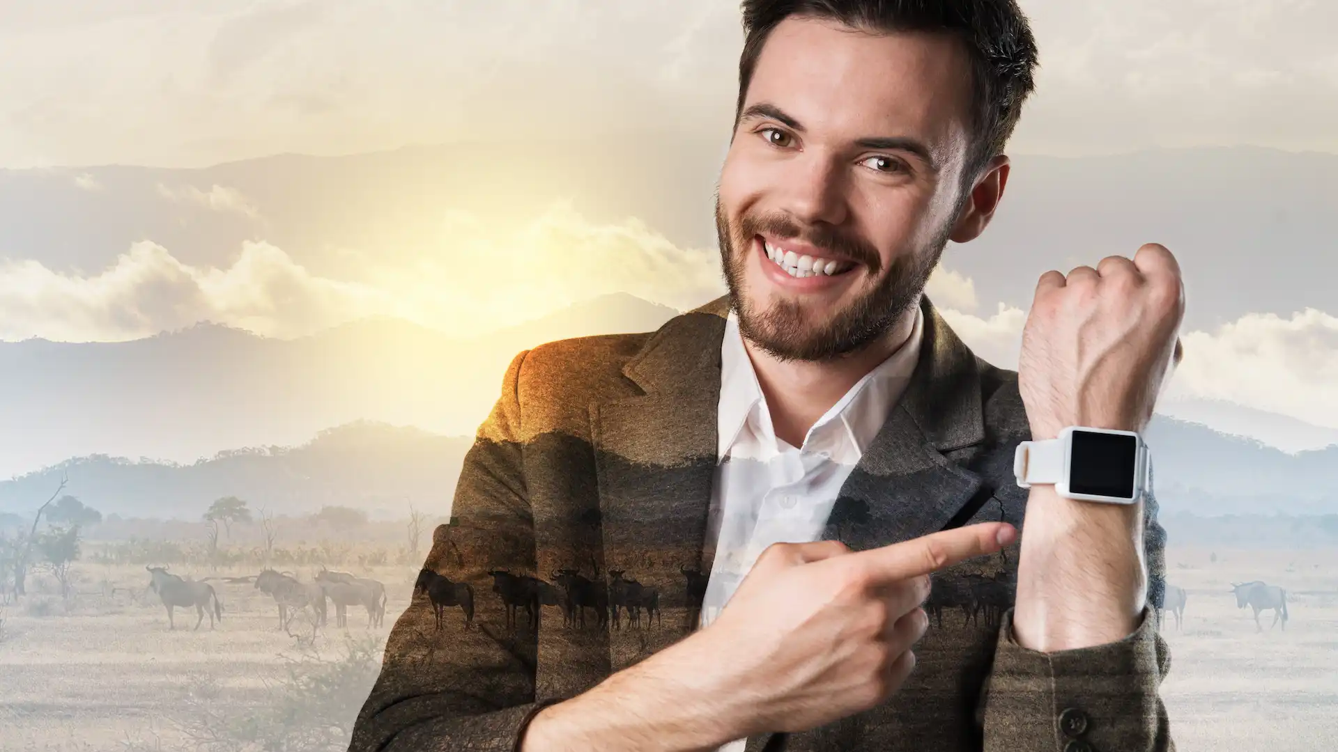 smiling young man pointing at smartwatch device