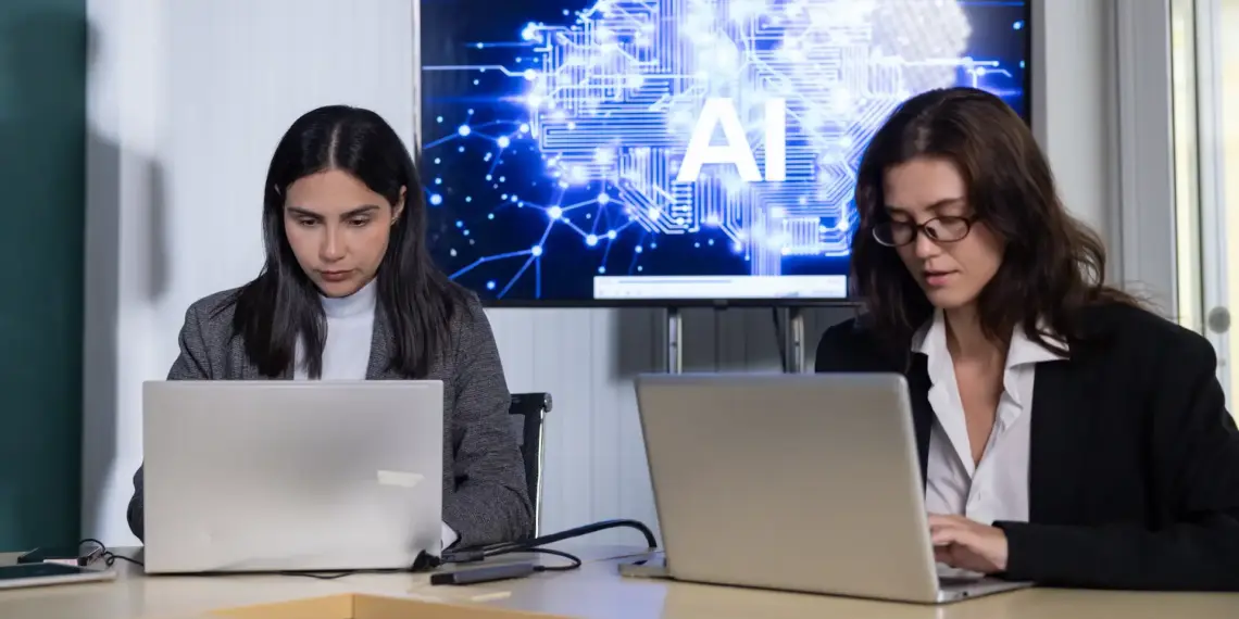 women using laptops in modern workplace with ai