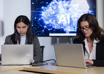 women using laptops in modern workplace with ai